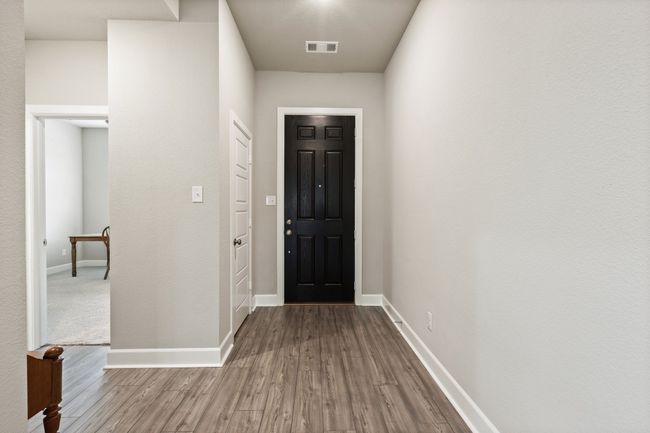 As you enter through the front door, you see the luxury vinyl plank flooring throughout from the front of the house to the back. | Image 5