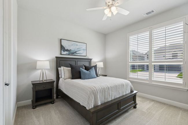 Bedroom featuring light colored carpet and a ceiling fan | Image 23