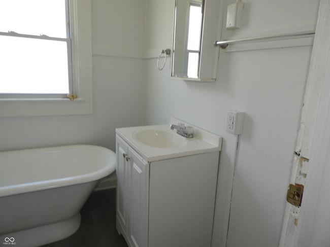 bathroom featuring a soaking tub, a wealth of natural light, and vanity | Image 8