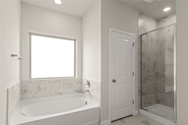 Bathroom with a garden tub, marble look tile flooring, a marble finish shower, and recessed lighting | Image 23