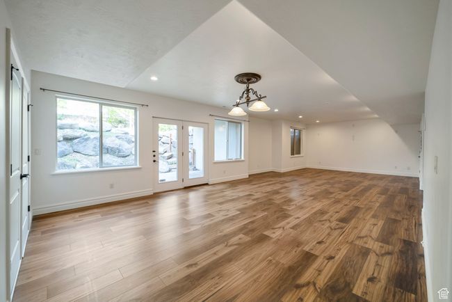 Unfurnished living room featuring wood finished floors, recessed lighting, and baseboards and walk out | Image 27