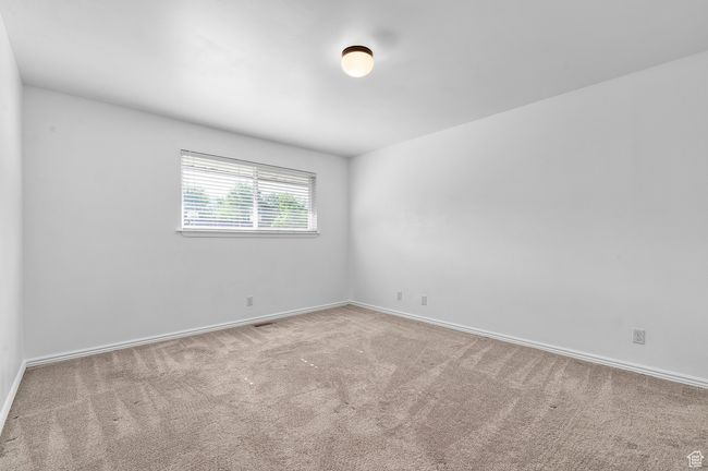 Bedroom with carpet floors and baseboards | Image 9