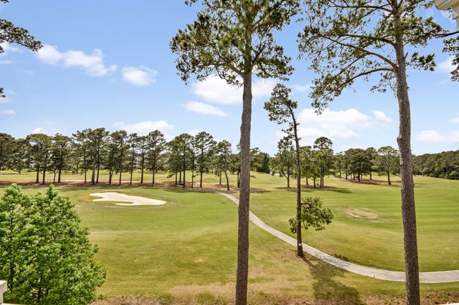 View of property's community with a yard and view of golf course | Image 21