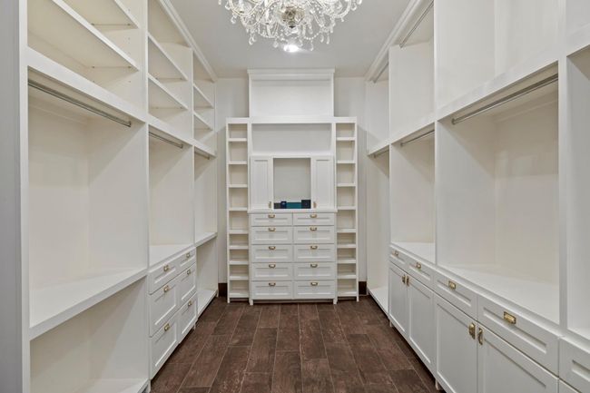 Large walk-in closet with built ins and chandelier. | Image 28