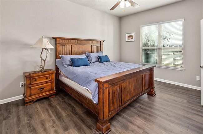 Bedroom featuring ceiling fan and dark hardwood / wood-style floors | Image 14