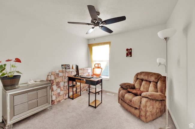 Office with ceiling fan and light carpet | Image 11