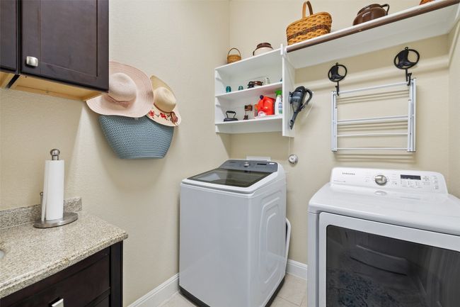 Laundry room provides space for full size washer & dryer, and a sink and cabinets for added functionality | Image 37