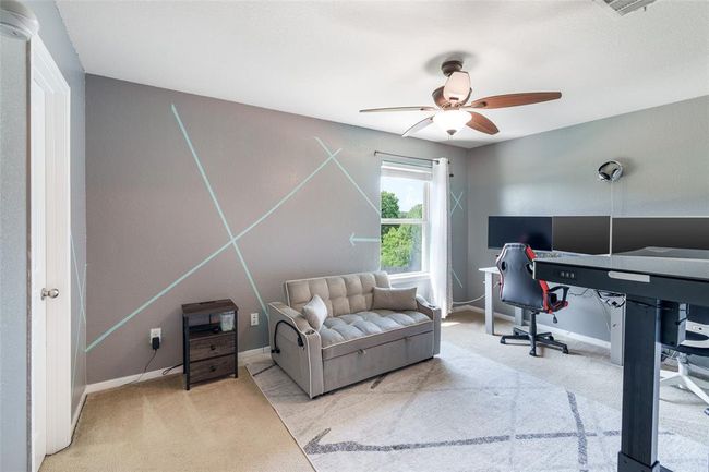 This beautifully designed bedroom features custom paint, a window with privacy blinds, and plush carpet flooring for a modern and cozy feel! | Image 14
