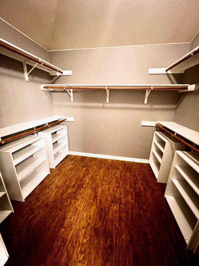 Spacious closet with wood finished floors | Image 13