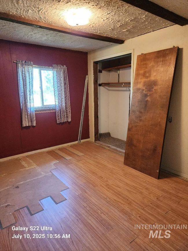 Unfurnished bedroom featuring a closet and partially finished floors | Image 25