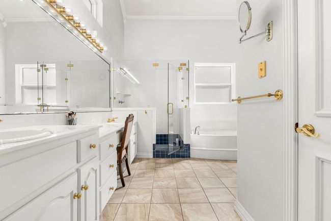 Full bathroom with ornamental molding, a stall shower, vanity, and a jetted bathtub | Image 21