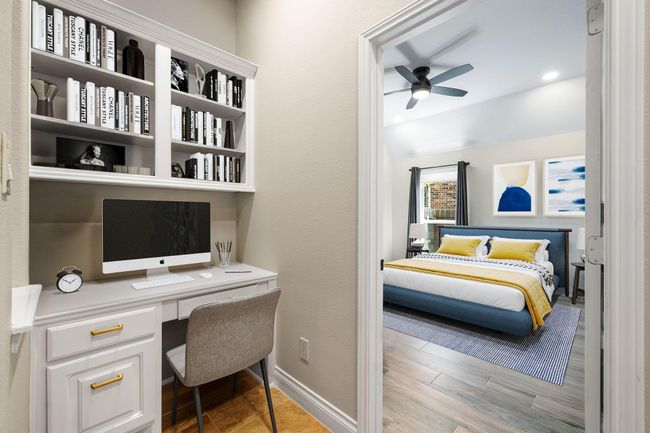 A built-in office nook adds functionality, while arched doorways lead seamlessly into the heart of the home. | Image 29