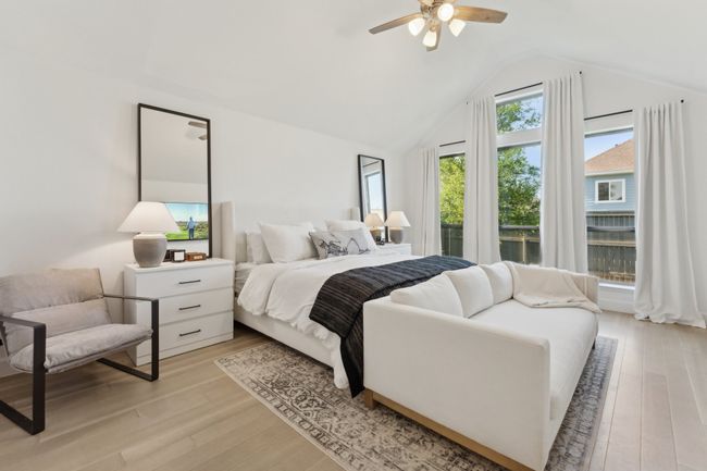 Bedroom featuring lofted ceiling, light wood-style flooring, and ceiling fan | Image 16
