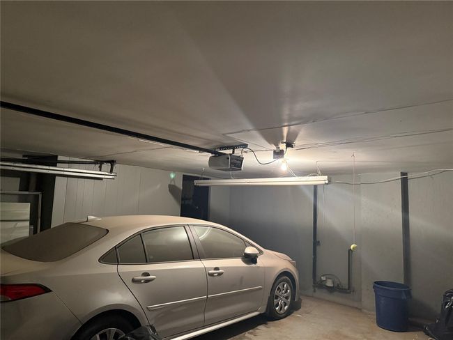 Garage with a garage door opener and a decorative wall | Image 21