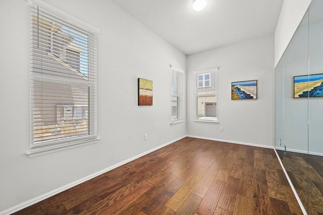 Empty room featuring wood-type flooring and healthy amount of natural light | Image 16