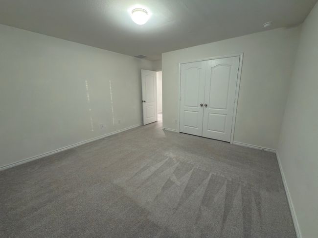 Unfurnished bedroom with carpet flooring, baseboards, and a closet | Image 25