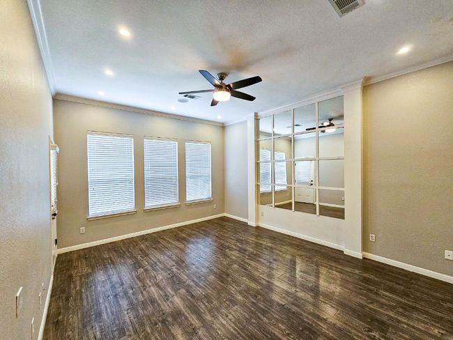 Spare room with crown molding, ceiling fan, wood finished floors, recessed lighting, and baseboards | Image 13