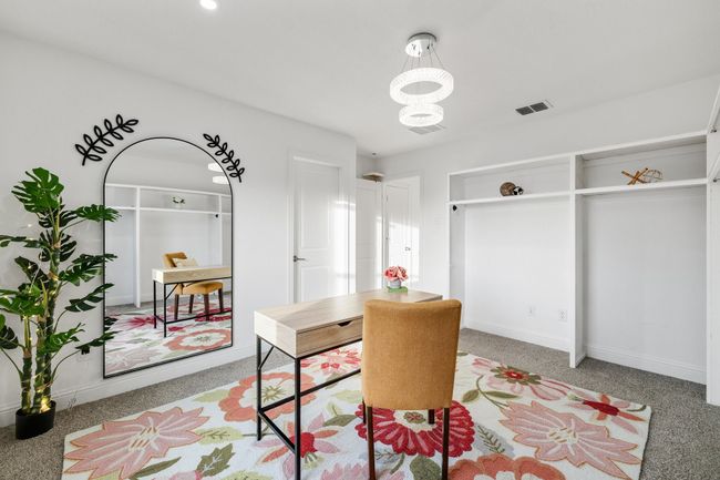 Dining space with carpet flooring and an inviting chandelier | Image 22