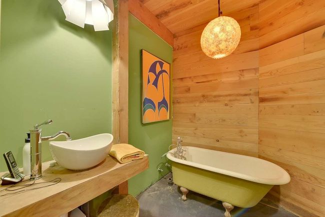 Bathroom with wood walls, a freestanding tub, concrete floors, and wood ceiling | Image 22