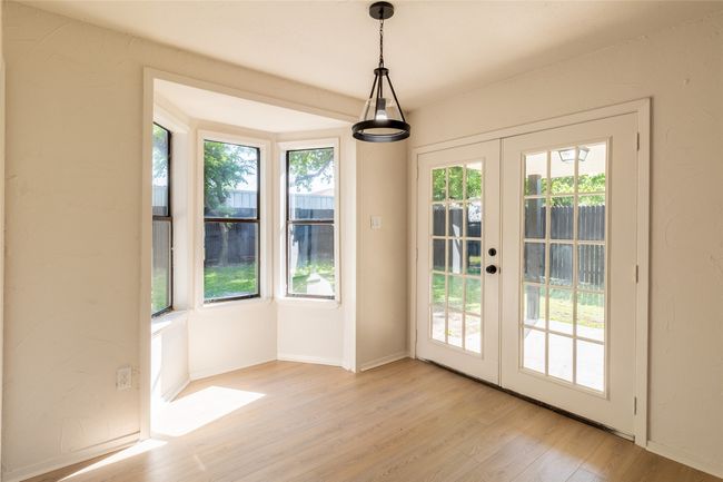 Entryway featuring baseboards, french doors, and light wood-type flooring | Image 11