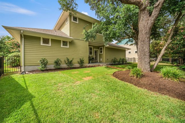 The lush landscaping in the backyard surrounds you with vibrant greenery, creating a serene and inviting atmosphere perfect for relaxing or entertaining | Image 34