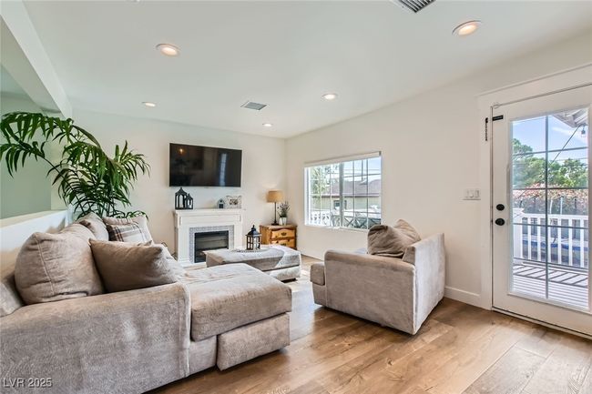 Living room with plenty of natural light, light wood finished floors, recessed lighting, and baseboards | Image 6