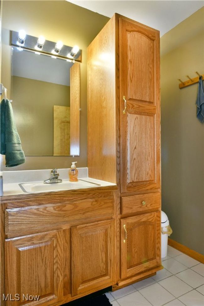 Bathroom with tile patterned flooring, toilet, and vanity | Image 44