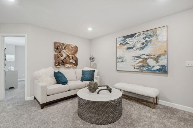 (Photo of a decorated model, actual homes finishes will vary) Located on the upper level, this perfectly sized living space has enough room for a desk, television and seating for all. Plus, it is just steps away from the three bedrooms. | Image 7