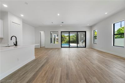 Unfurnished living room featuring sink and light wood-type flooring | Image 3