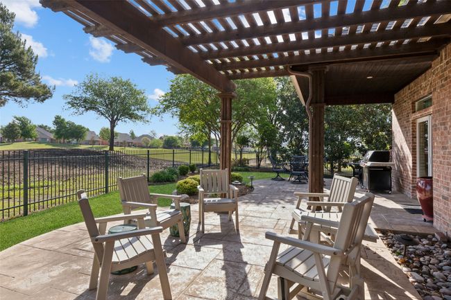 Large covered back patio with views of golf course | Image 25