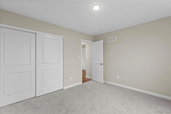 Unfurnished bedroom featuring carpet floors, baseboards, and a closet | Image 6