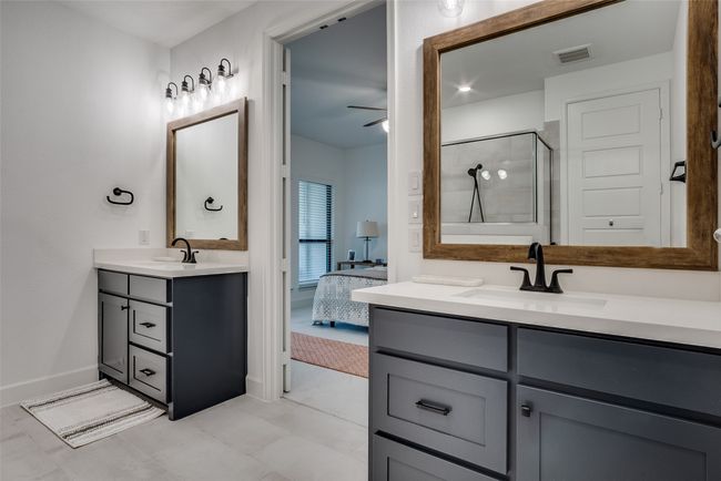 Ensuite bathroom featuring vanity, a stall shower, and ceiling fan | Image 24