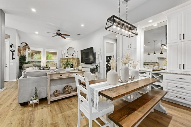Dining room with ceiling fan, recessed lighting, and high ceilings. | Image 6