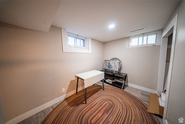 Below grade area with wood finished floors and baseboards | Image 21