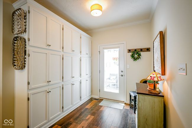 foyer with dark wood-style flooring, crown molding, and baseboards | Image 18