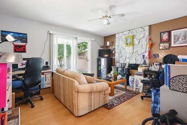 Office with wood walls, wood finished floors, and ceiling fan | Image 7
