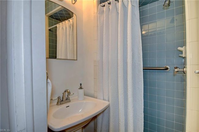 Hall bath features a vintage tile stand up shower. | Image 34