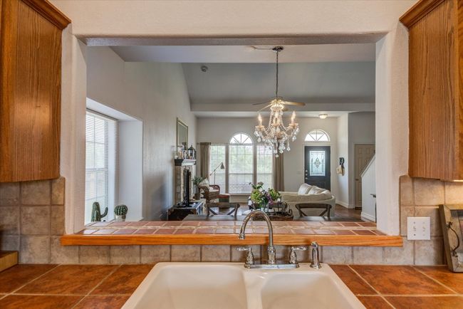 The kitchen features a pass-through window to the formal dining room, and a nice space here to set up a buffet. | Image 9