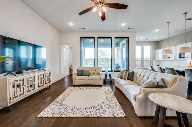 Living room with ceiling fan, dark wood-type flooring, recessed lighting, and baseboards | Image 9