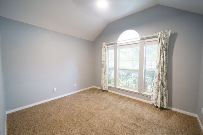 Bedroom featuring lofted ceiling, carpet flooring, and baseboards | Image 22