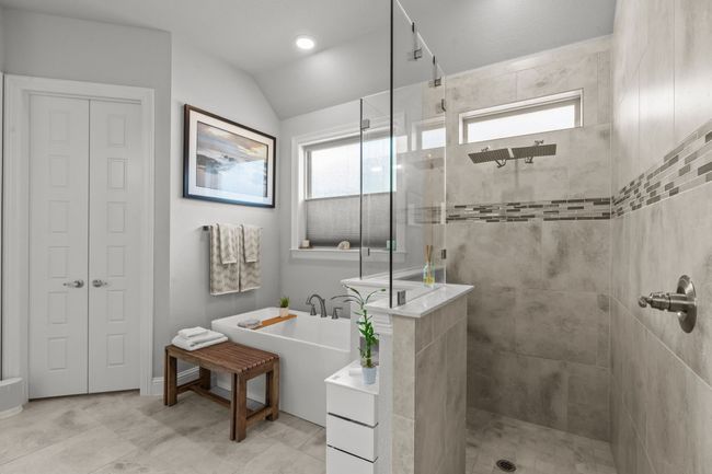 Bathroom featuring tiled shower, a soaking tub, and vaulted ceiling | Image 18