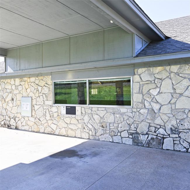 View of side of property with stone siding and a patio | Image 4