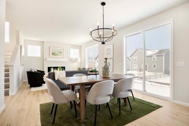 The dining room seamlessly opens to an 8-foot patio door, enhancing the flow between indoor and outdoor living. Photos are from previously built home; options and features will vary. | Image 9