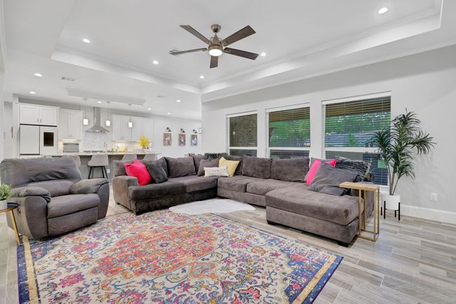 Elegant living area bathed in natural light from stunning, expansive windows. | Image 14