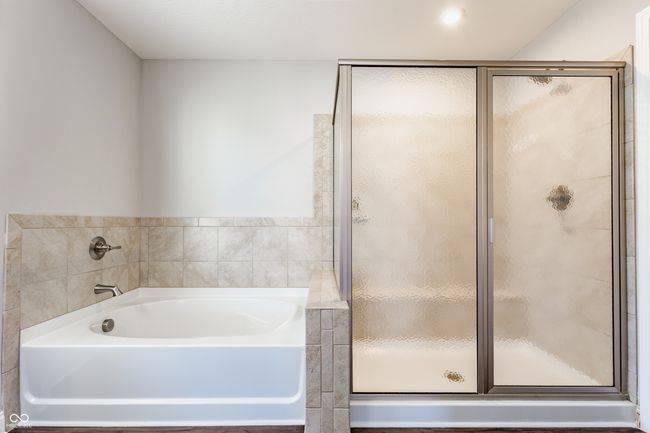 bathroom featuring a bath and a stall shower | Image 29