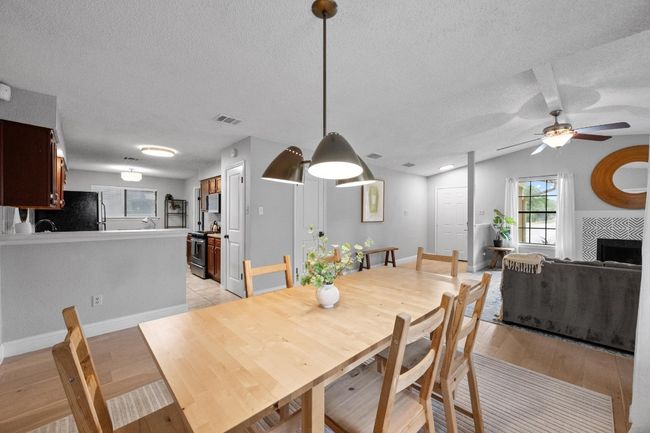 Dining area looking into kitchen and living room. | Image 8