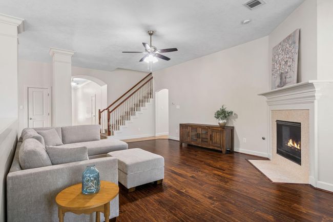Living area with staircase to large game room. | Image 13