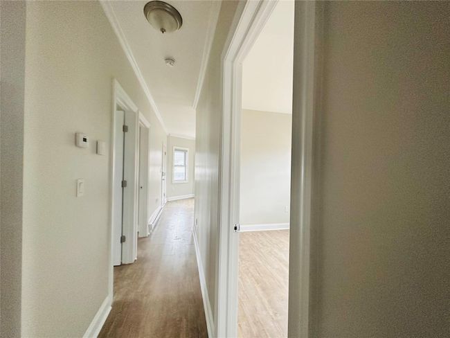 Corridor featuring wood-type flooring and crown molding | Image 10