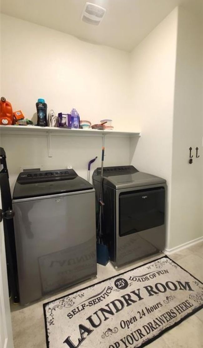 Laundry area with washing machine and clothes dryer | Image 13