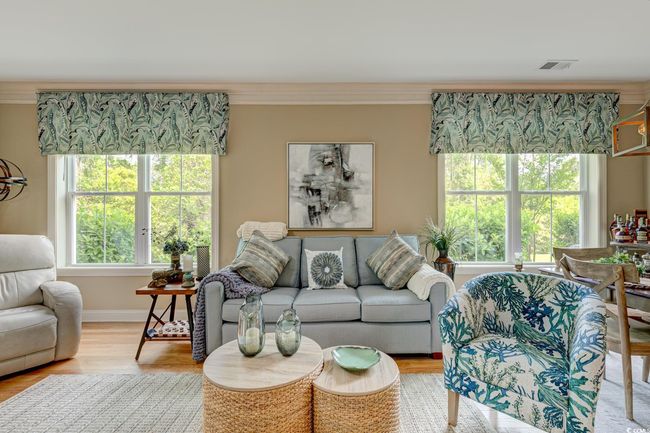 Living room with ceiling fan, baseboards, ornamental molding, and light wood-type flooring | Image 13